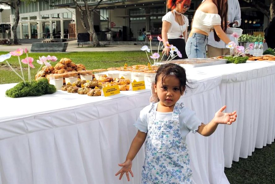 A toddler in front of the matcha raspberry cookies