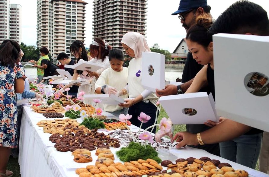 Guests filling cookie boxes along a long table