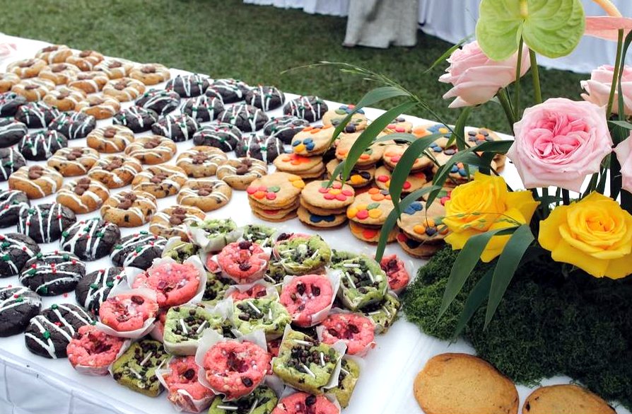 Iced cookies beside roses at Cookie Picnic