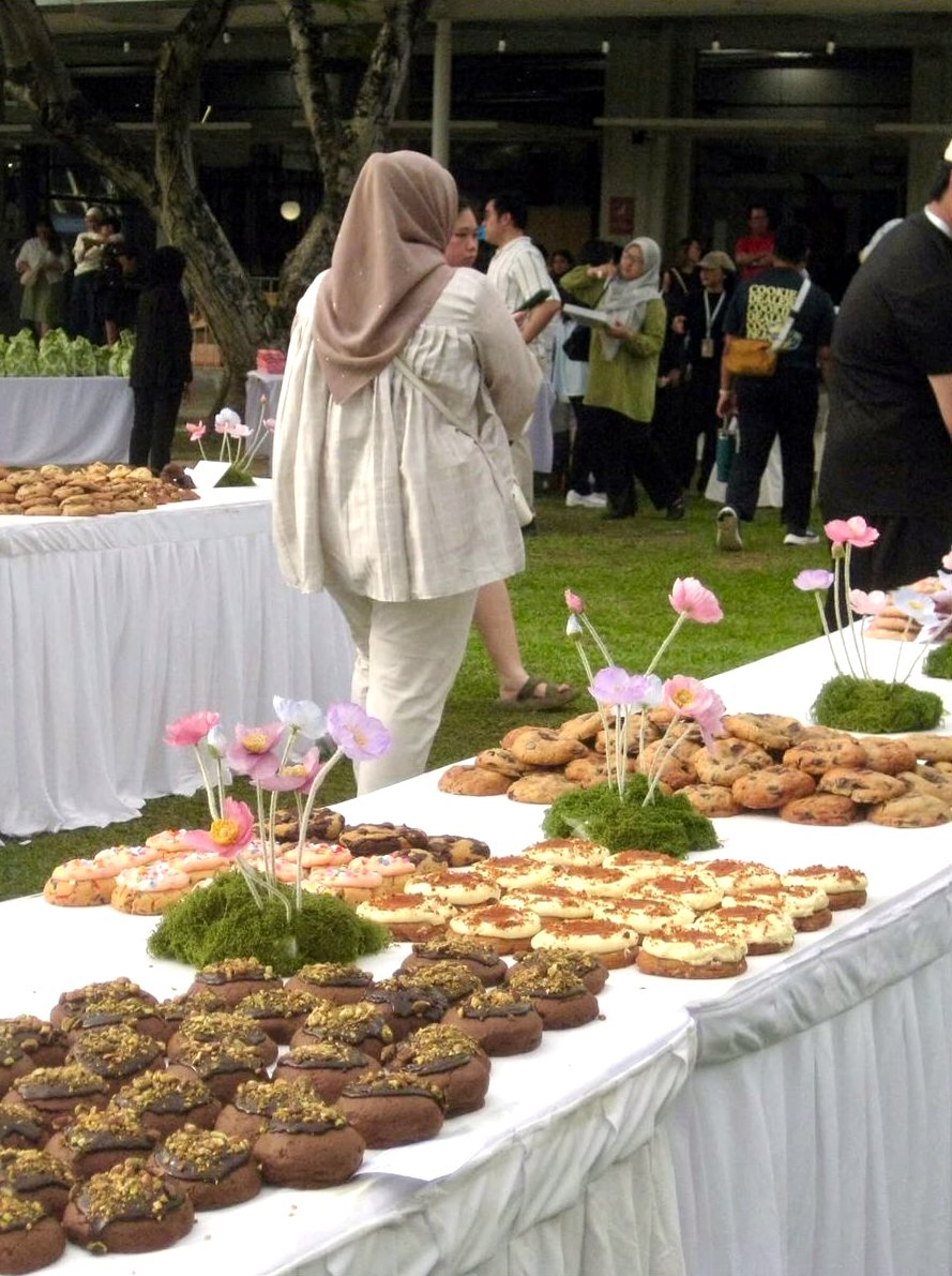 A guest walking between cookie tables