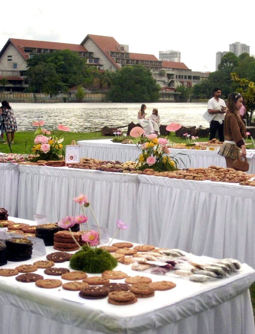 Cookie tables with flowers and the lake behind